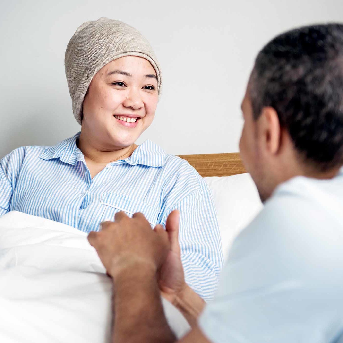 A sick woman in bed with her partner