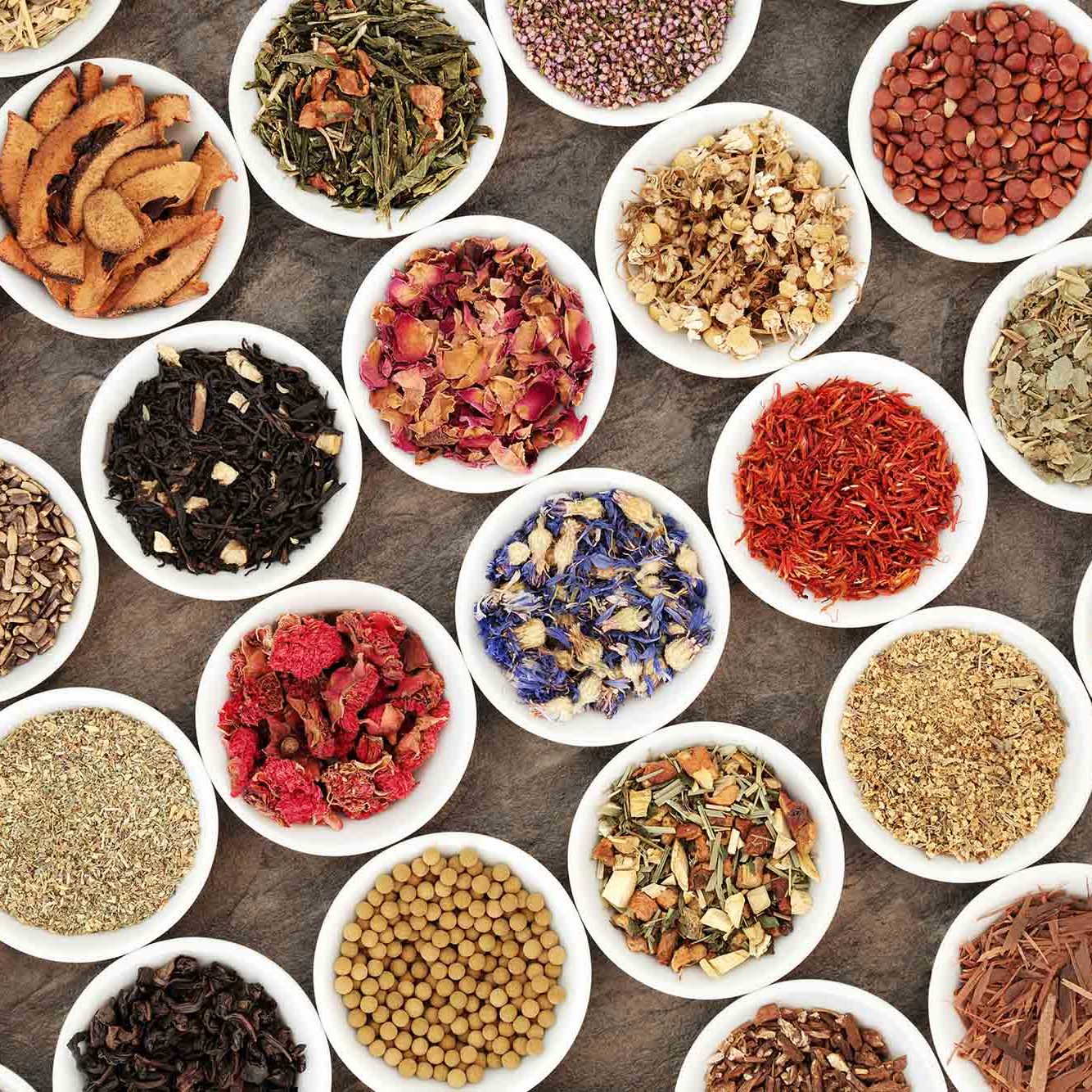 Healthy herb tea collection in china bowls forming an abstract background. Teas also used in herbal medicine.